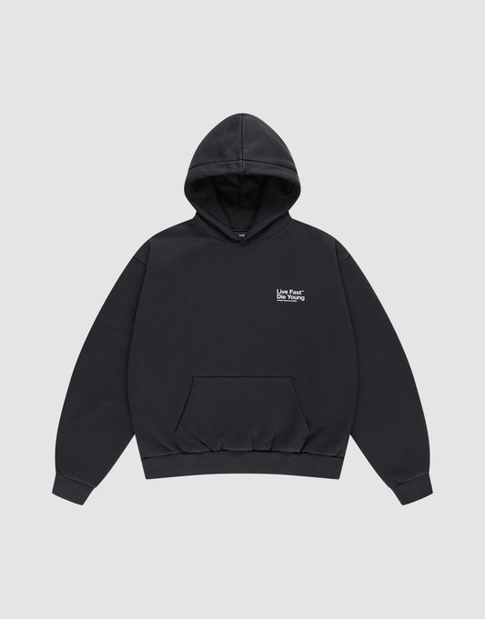 The Live Fast NY Hooded by LIVE FAST DIE YOUNG is a black oversized cotton hoodie with a front pocket and small white "Love Fear Love Yourself" text on the left chest, shown laid flat on a light gray background.