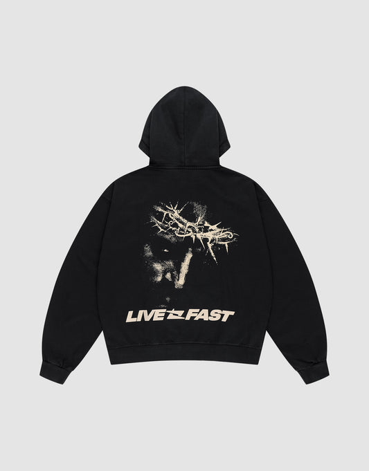 The LFDY Savior Hooded by LIVE FAST DIE YOUNG is an oversize black sweatshirt in 100% Baumwolle, featuring an abstract scratched beige graphic and Logo Stick on the back with “LIVE FAST” text at the bottom. Shown on a light gray background. | plain