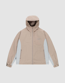 The Basic Shell Jacket by LIVE FAST DIE YOUNG in beige and light gray features an oversize fit, hood, front zipper, two zippered side pockets, and elastic cuffs. Shown on a plain light gray background. | plain