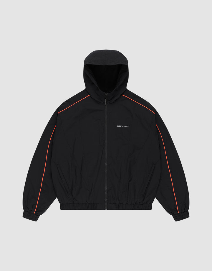 The Live Fast Trackjacket by LIVE FAST DIE YOUNG is a black zip-up hoodie with red piping on the shoulders and sleeves, elastic cuffs and hem, zippered side pockets, and small white LIFE SUX ART text on the left chest, shown on a light gray background. | plain