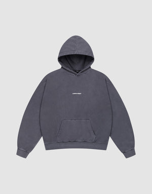 The LFDY Core Hooded by LIVE FAST DIE YOUNG is an oversized dark gray hoodie with a front "LIVE FAST" print in small white letters, 100% Baumwolle, front pocket, shown on a plain light gray background. | plain