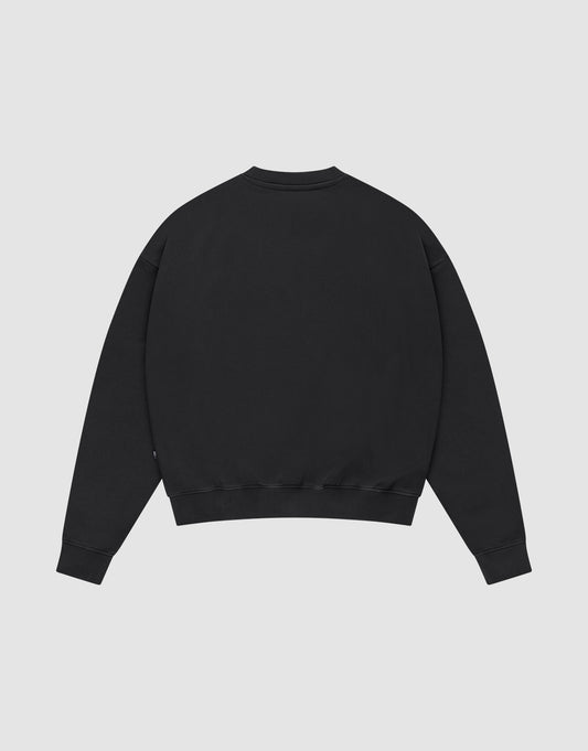 The LFDY Supply Sweater by LIVE FAST DIE YOUNG is shown laid flat, back up, on a light gray background. This oversized black crewneck features a soft Baumwolle-Polyester blend, long sleeves, and ribbed cuffs and hem.