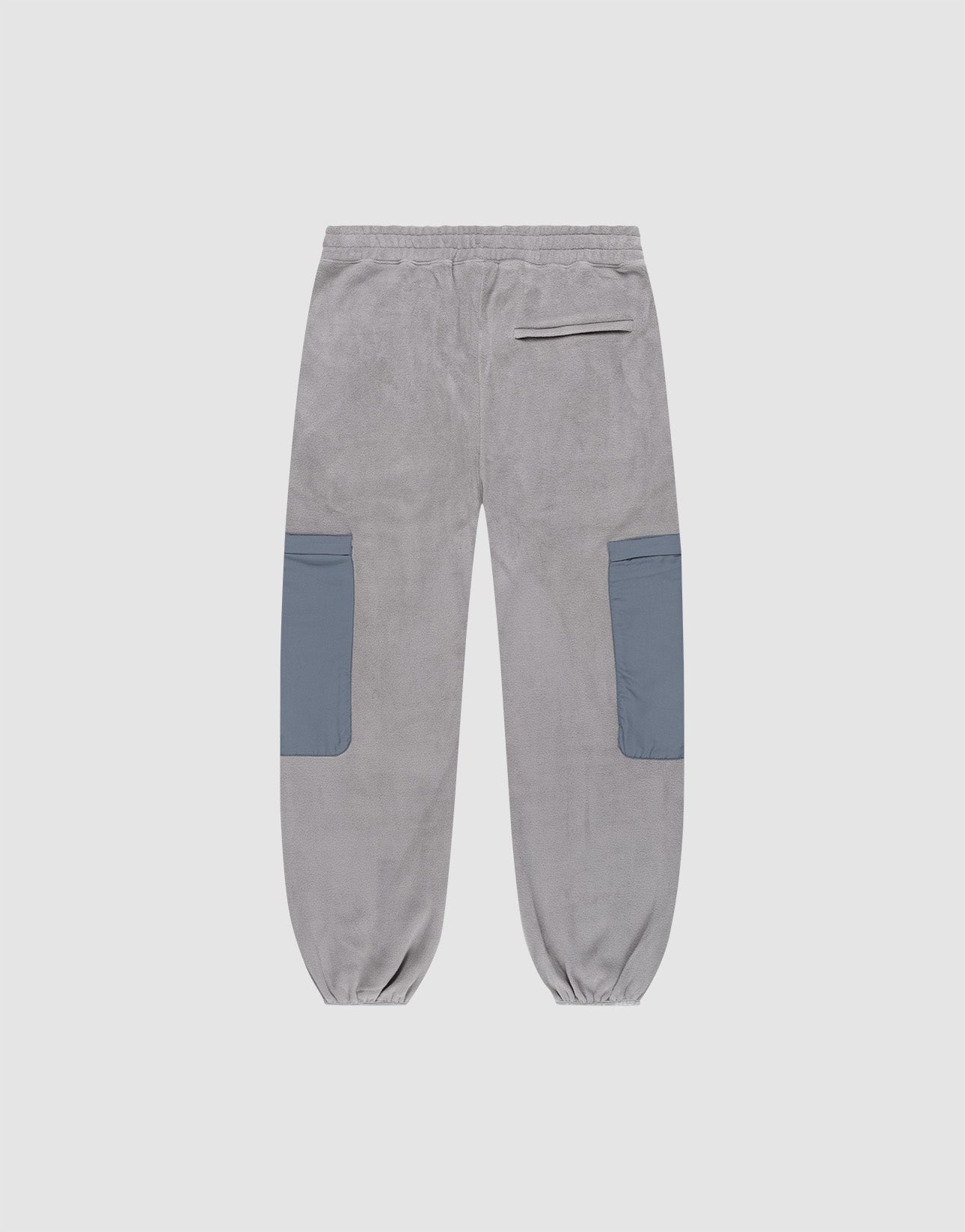The Live Fast Fleece Pants by LIVE FAST DIE YOUNG feature a gray wide fit, Elastic-Bund waist, elastic cuffs, two large blue nylon side pockets, and a single zippered back pocket. Displayed on a white background.