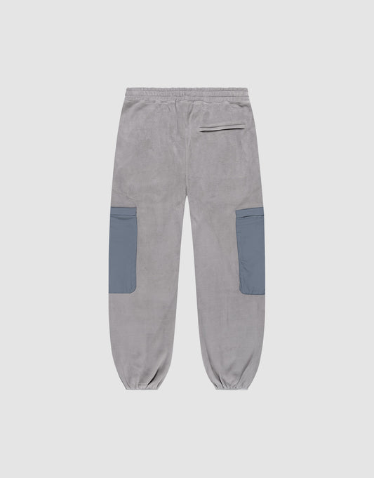 The Live Fast Fleece Pants by LIVE FAST DIE YOUNG feature a gray wide fit, Elastic-Bund waist, elastic cuffs, two large blue nylon side pockets, and a single zippered back pocket. Displayed on a white background.
