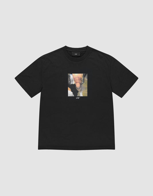 The LIVE FAST DIE YOUNG LFDY Sharkhunter Tee is a black, short-sleeve oversized shirt in soft cotton, featuring a square abstract photo graphic with "LIFT" printed below the image in white. Laid flat on a plain light background. | plain
