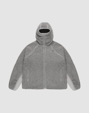 The LIVE FAST DIE YOUNG Live Fast Teddy Jacket is a gray, oversize-fit Kapuzenjacke with a high collar, zip-up front, raglan sleeves, and two side pockets, shown flat on a plain light background. | plain