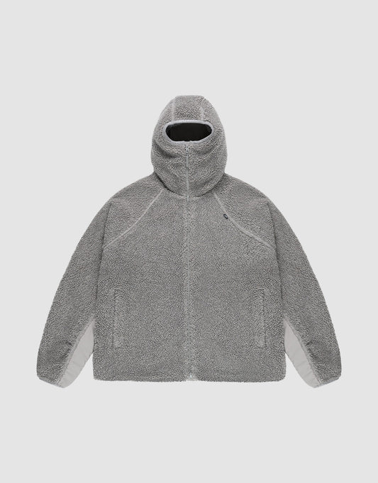 The LIVE FAST DIE YOUNG Live Fast Teddy Jacket is a gray, oversize-fit Kapuzenjacke with a high collar, zip-up front, raglan sleeves, and two side pockets, shown flat on a plain light background. | plain