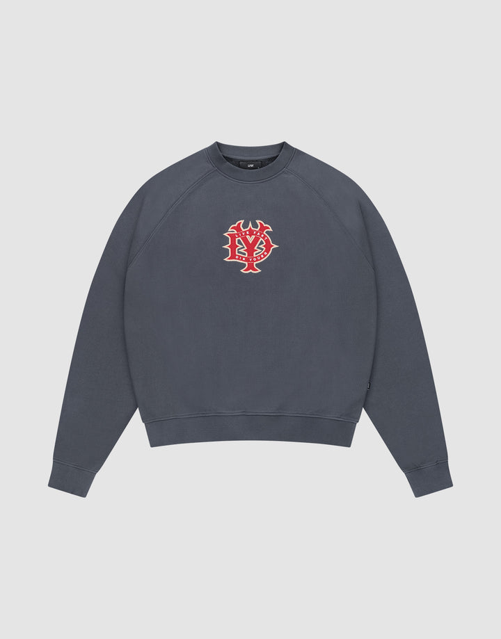 The DY Sweater by LIVE FAST DIE YOUNG is a dark gray crewneck with Raglan sleeves and a red and white abstract face graphic on the chest, shown against a plain white background. | plain