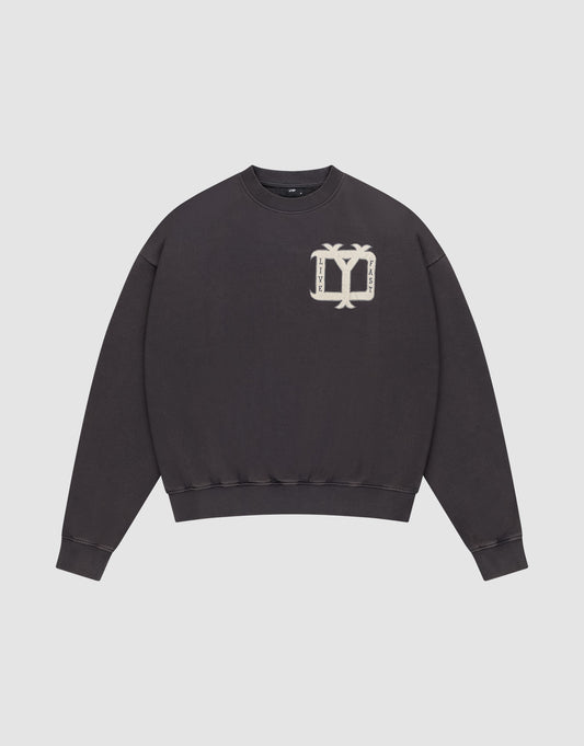 Ein schwarzer "Live Fast DY Sweater" von LIVE FAST DIE YOUNG aus Baumwolle mit beiger Vintage-Grafik (zwei Palmen, gespiegelter Text) auf der linken Brust vor weißem Hintergrund. | plain