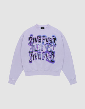 The Triple Sweater by LIVE FAST DIE YOUNG is an oversize fit lavender crewneck with "LIVE FV5T" printed three times in bold, distorted purple and black on the front. Crafted from soft Baumwolle and shown flat on a white background. | plain