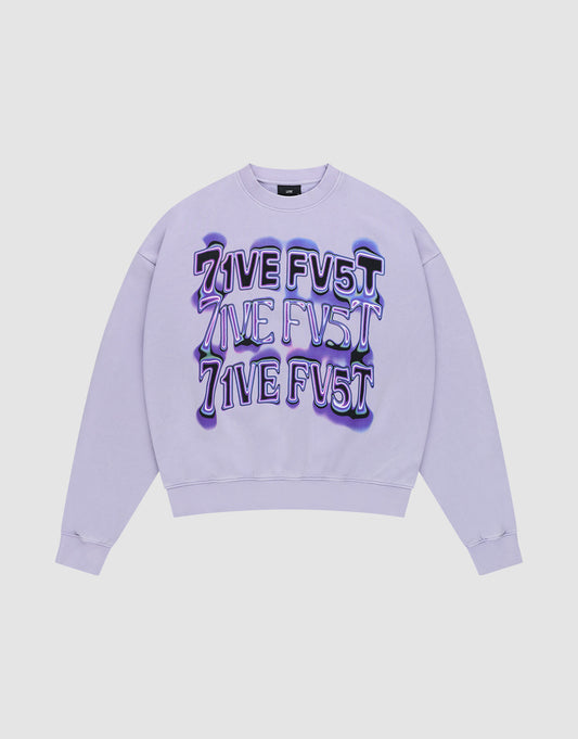 The Triple Sweater by LIVE FAST DIE YOUNG is an oversize fit lavender crewneck with "LIVE FV5T" printed three times in bold, distorted purple and black on the front. Crafted from soft Baumwolle and shown flat on a white background. | plain
