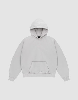 The LIVE FAST DIE YOUNG Basic Blank Hooded is an oversized light gray hoodie made from soft Baumwolle, featuring a front pouch pocket, long sleeves, ribbed cuffs and hem, and neat topstitching—displayed on a white background. | plain