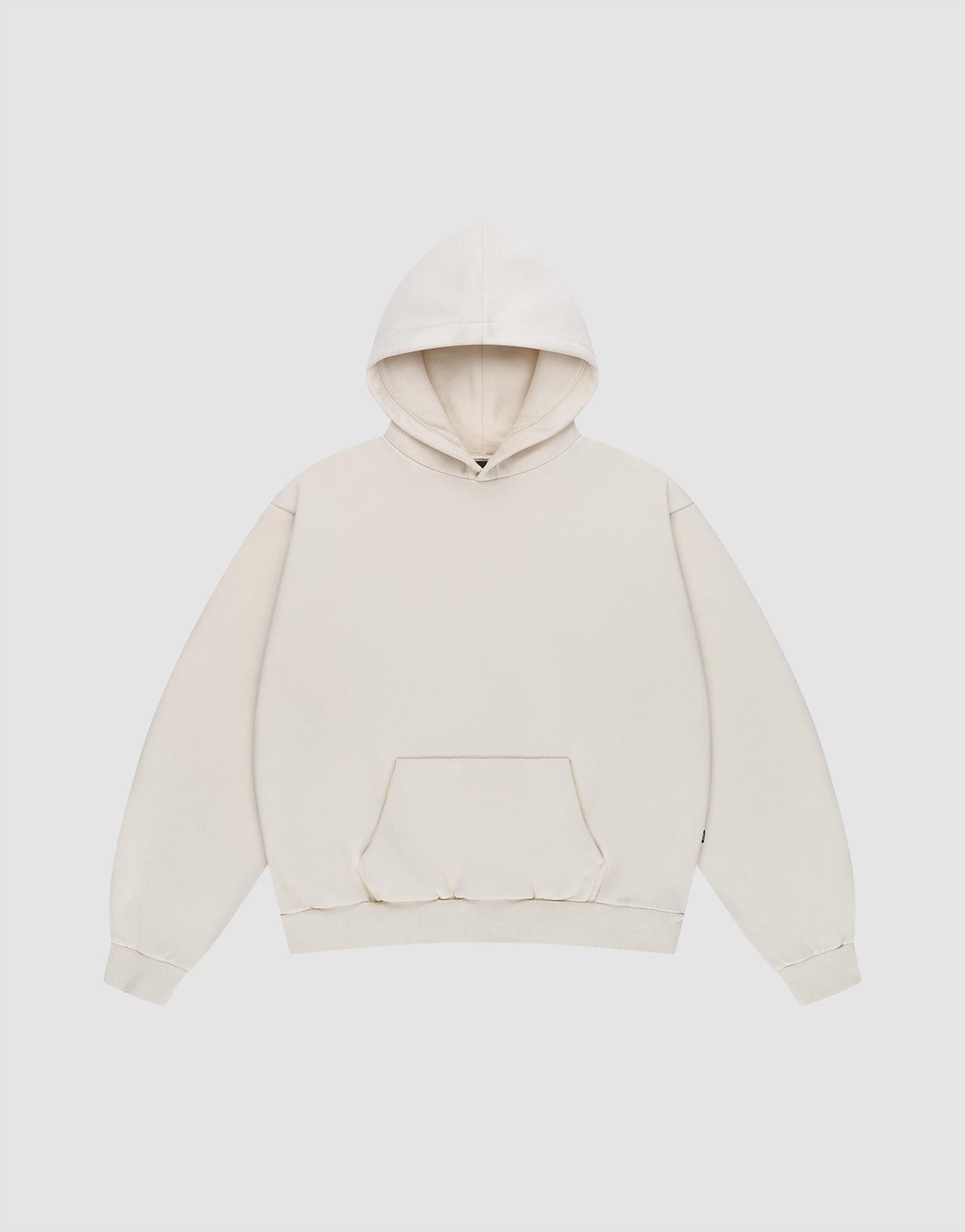 The Basic Blank Hooded by LIVE FAST DIE YOUNG is a plain, oversized off-white hooded sweatshirt with a front kangaroo pocket, ribbed cuffs, and subtle Flag-Label detail, shown flat on a light gray background.