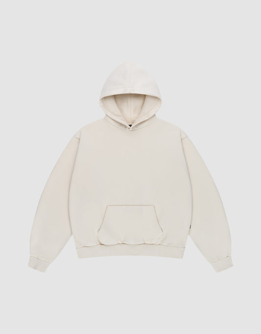 The Basic Blank Hooded by LIVE FAST DIE YOUNG is a plain, oversized off-white hooded sweatshirt with a front kangaroo pocket, ribbed cuffs, and subtle Flag-Label detail, shown flat on a light gray background. | plain