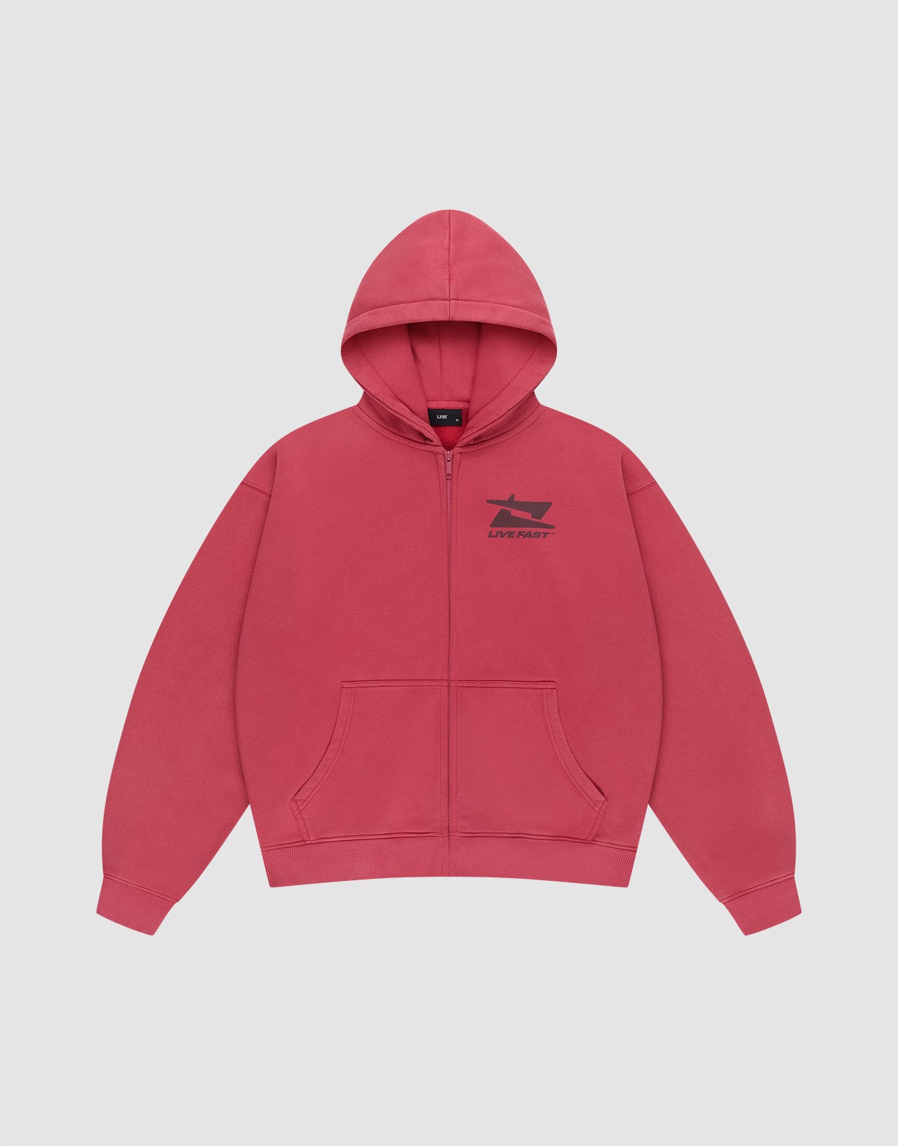 The Live Fast Sweatsuit Jacket by LIVE FAST DIE YOUNG is a pink oversized zip-up hoodie with front pockets, a hood, and a small black boat graphic with "LIVE FAST" on the left chest, displayed on a light gray background.