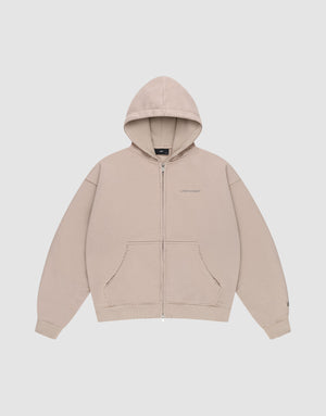 The LFDY Double Hooded Zip by LIVE FAST DIE YOUNG is a beige oversize hoodie with a front pocket, drawstring hood, subtle LIVEST FAST text on the left chest, and soft waffle lining, shown laid flat on a plain white background. | plain