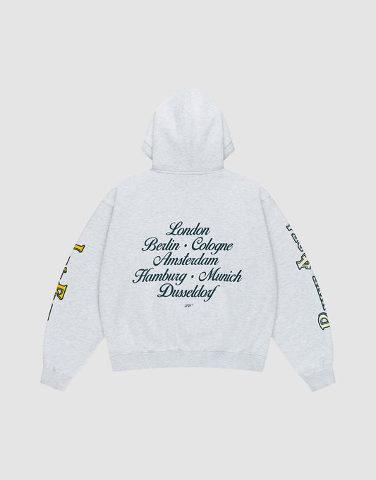 The LIVE FAST DIE YOUNG "Rhine Area Hooded" is a light gray oversized hoodie with drawstring hood, yellow and green sleeve prints, and black cursive European city names across the back. | plain