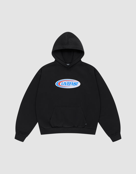 The Live Fast Garment Hooded by LIVE FAST DIE YOUNG is an oversized black hoodie with a front pocket and a blue/red oval "LIVE FAST" chest logo. Made from soft Baumwolle. Background: light gray. | plain