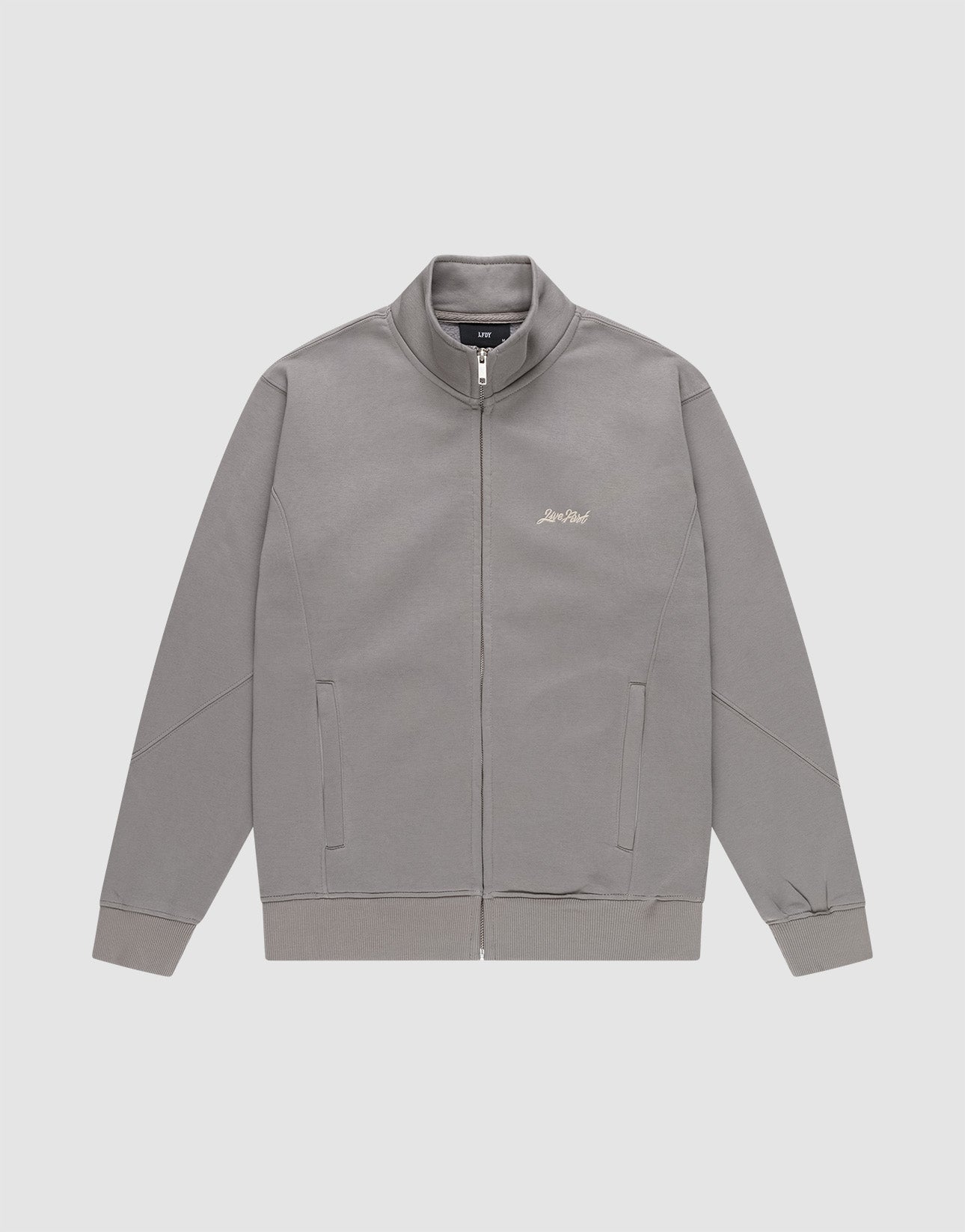 The LIVE FAST DIE YOUNG Sweatsuit Jacket is a gray, regular-fit zip-up with a stand collar, angled side pockets, and subtle small light-colored script on the left chest, shown on a plain white background.