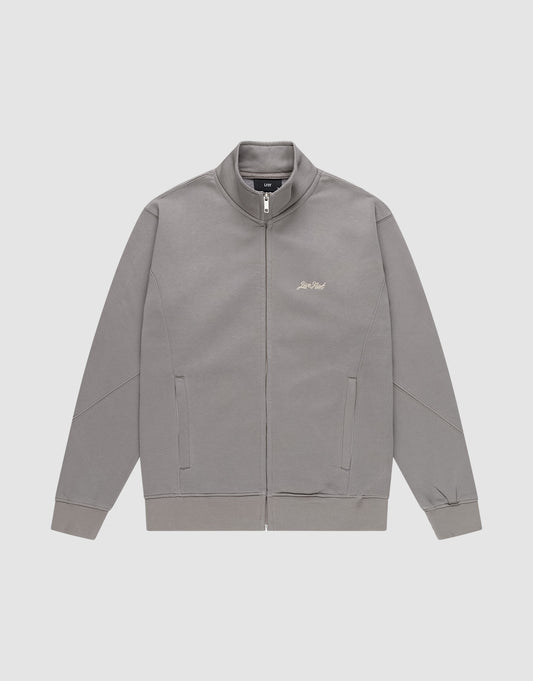 The LIVE FAST DIE YOUNG Sweatsuit Jacket is a gray, regular-fit zip-up with a stand collar, angled side pockets, and subtle small light-colored script on the left chest, shown on a plain white background.