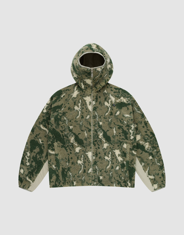 The Live Fast Teddy Jacket by LIVE FAST DIE YOUNG features a hood with visor opening, green/beige/white camouflage pattern, front zipper, and white panels on the lower sleeve sides, shown against a plain light gray background. | plain