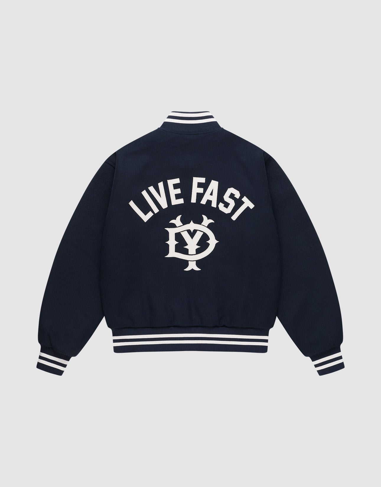 The Live Fast College Jacket by LIVE FAST DIE YOUNG is a navy varsity jacket with white striped cuffs, collar, and hem. The back features bold "LIVE FAST" Rückenstick text above an LV circular emblem. Regular fit for comfort and style.