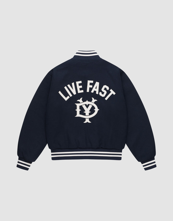 The Live Fast College Jacket by LIVE FAST DIE YOUNG is a navy varsity jacket with white striped cuffs, collar, and hem. The back features bold "LIVE FAST" Rückenstick text above an LV circular emblem. Regular fit for comfort and style. | plain