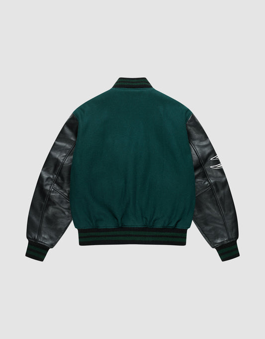 The Life College Jacket by LIVE FAST DIE YOUNG features green fabric, black leather sleeves, ribbed cuffs and waistband, a white embroidered detail on the right sleeve, and a terry patch—shown from the back on a light gray background.