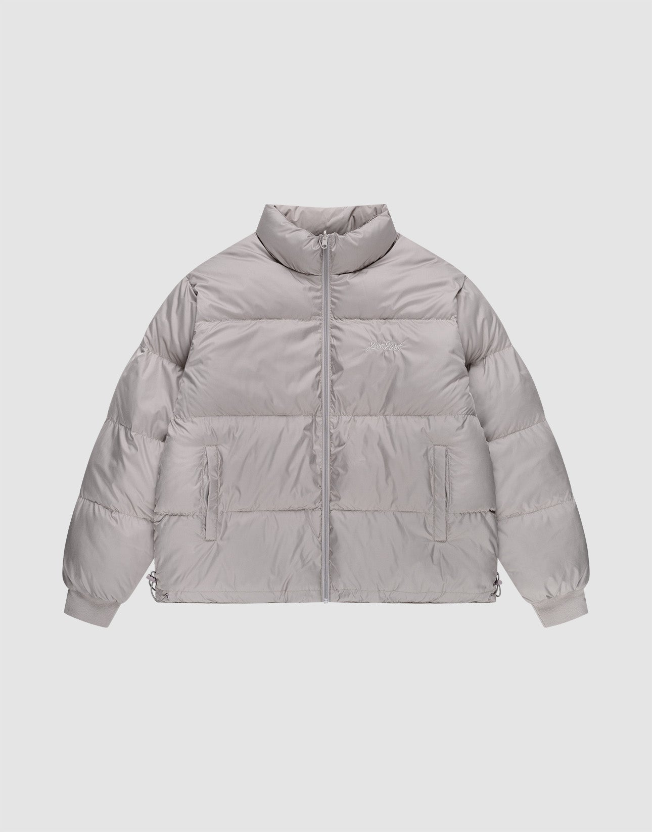 The LFDY Puffer Jacket by LIVE FAST DIE YOUNG features a light gray oversized fit, high collar, front zipper closure, two side pockets, and elastic cuffs, shown on a plain white background. | plain