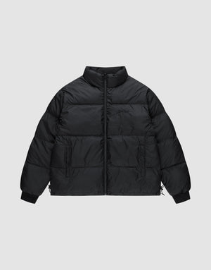 The LFDY Puffer Jacket by LIVE FAST DIE YOUNG features an oversized black design with a high collar, front logo stitching, zipper closure, side pockets, and elastic cuffs, shown against a plain light gray background. | plain