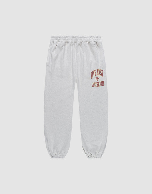 The Live Fast Amsterdam Loose Jogger by LIVE FAST DIE YOUNG features light gray, loose-fit 100% cotton sweatpants with a wide elastic waistband, cuffs, and bold red "LIVE FAST" lettering plus graphic prints on the left thigh for all-day comfort. | plain