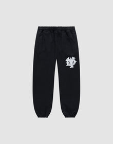 The DY Loose Jogger by LIVE FAST DIE YOUNG are black sweatpants with a loose fit, elastic waistband, cuffs, and a white abstract face graphic on the upper left thigh. Made from soft cotton, shown against a plain light gray background. | plain