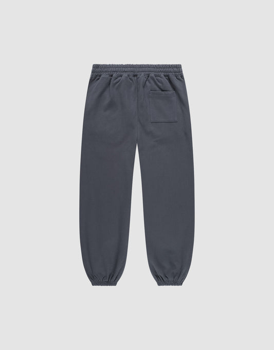 The DY Loose Jogger by LIVE FAST DIE YOUNG are dark gray, loose fit sweatpants with an elastic waistband, elastic cuffs, and a single back patch pocket, crafted from soft cotton and shown flat on a light gray background.