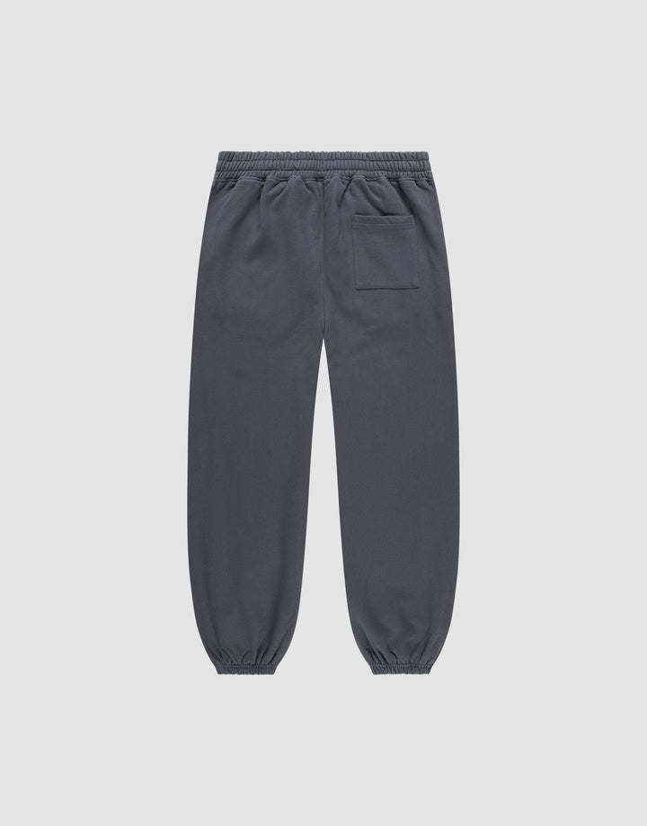 The DY Loose Jogger by LIVE FAST DIE YOUNG are dark gray, loose fit sweatpants with an elastic waistband, elastic cuffs, and a single back patch pocket, crafted from soft cotton and shown flat on a light gray background.