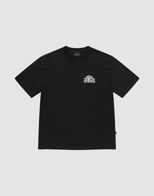 The LFDY Real Ones Tee by LIVE FAST DIE YOUNG is a black, oversize fit, short-sleeve shirt with a small white “The Real Street Real Ones” front graphic. Made from 100% Baumwolle and shown laid flat on a light gray background.
