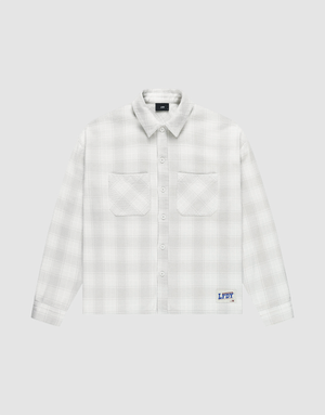 The LIVE FAST DIE YOUNG Vintage Flannel is a white plaid oversize long-sleeve shirt with two chest pockets, vintage wash, and a blue logo patch above the hem on a light grey background. | plain