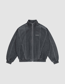The LFDY Denim Trackjacket by LIVE FAST DIE YOUNG is dark gray, 100% Baumwolle, with a front zipper, stand collar, elastic cuffs and hem, white seams, and "LIFE PAINT" in white text on the left chest. Shown laid flat on a light background. | plain