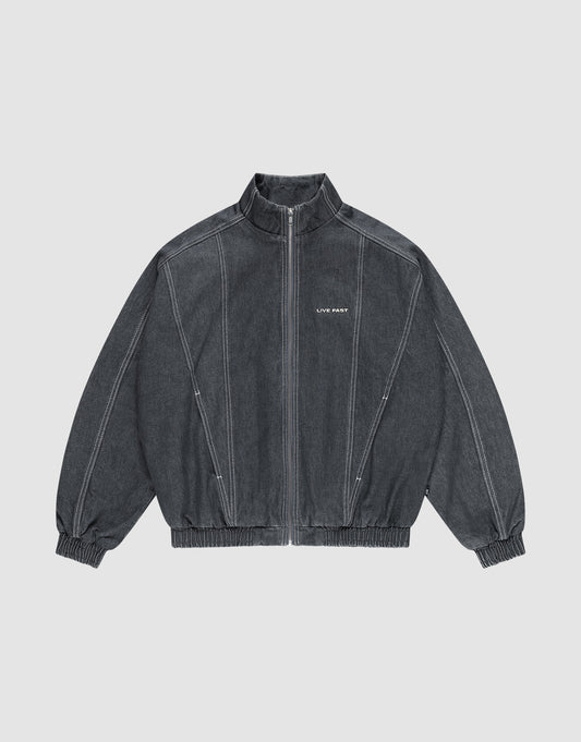 The LFDY Denim Trackjacket by LIVE FAST DIE YOUNG is dark gray, 100% Baumwolle, with a front zipper, stand collar, elastic cuffs and hem, white seams, and "LIFE PAINT" in white text on the left chest. Shown laid flat on a light background. | plain