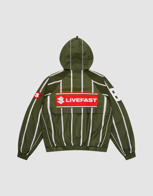 The LFDY Nylon Trackjacket by LIVE FAST DIE YOUNG is a green oversized jacket with a hood featuring an elastic drawstring, white vertical stripes, a bold red and white LIVEFAST backprint, "82" on the right sleeve, and a small red logo on the left. | plain