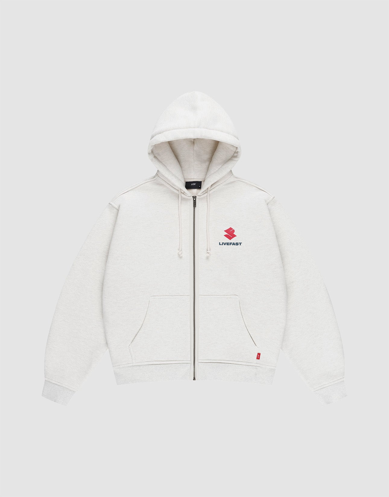 The LFDY Heavyweight Lounge Zip Hooded by LIVE FAST DIE YOUNG is a light gray, 100% Baumwolle zip-hoodie with front pockets, hood and drawstrings, minimalist design, and a small red Suzuki logo plus "LIVE FAST" on the left chest. Regular fit.