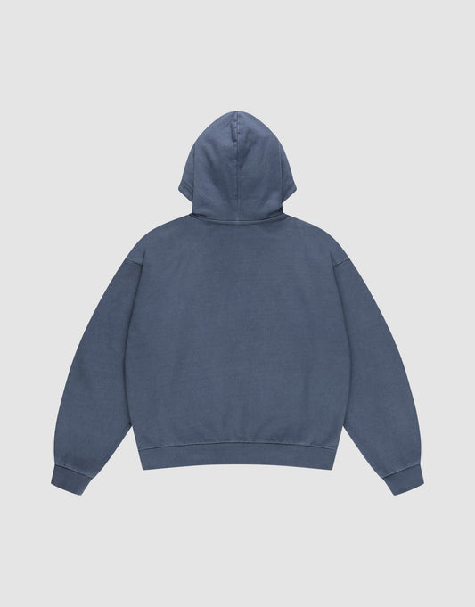 The LFDY Guaranteed Hooded Zip by LIVE FAST DIE YOUNG is shown from the back in plain blue, featuring an oversize fit, long sleeves, ribbed cuffs and waistband. Crafted from 100% Baumwolle and set against a light gray background.