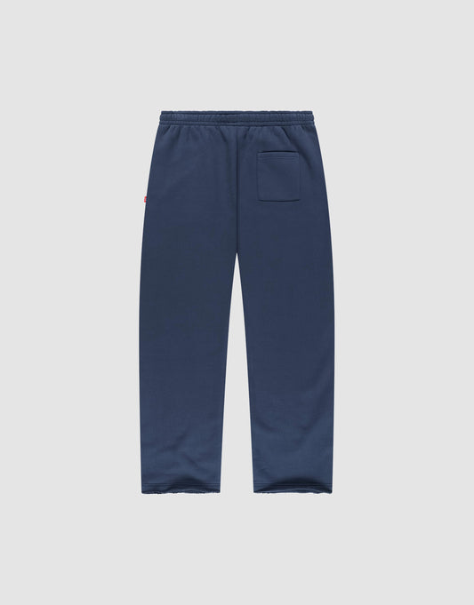 The LFDY Heavyweight Loungepants by LIVE FAST DIE YOUNG are navy blue wide fit joggers made from 100% cotton, with an elastic waistband and a single back pocket, shown flat on a plain light gray background.