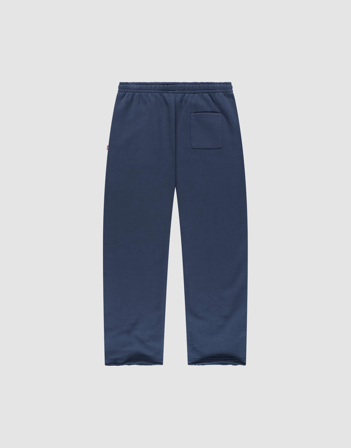 The LFDY Heavyweight Loungepants by LIVE FAST DIE YOUNG are navy blue wide fit joggers made from 100% cotton, with an elastic waistband and a single back pocket, shown flat on a plain light gray background.