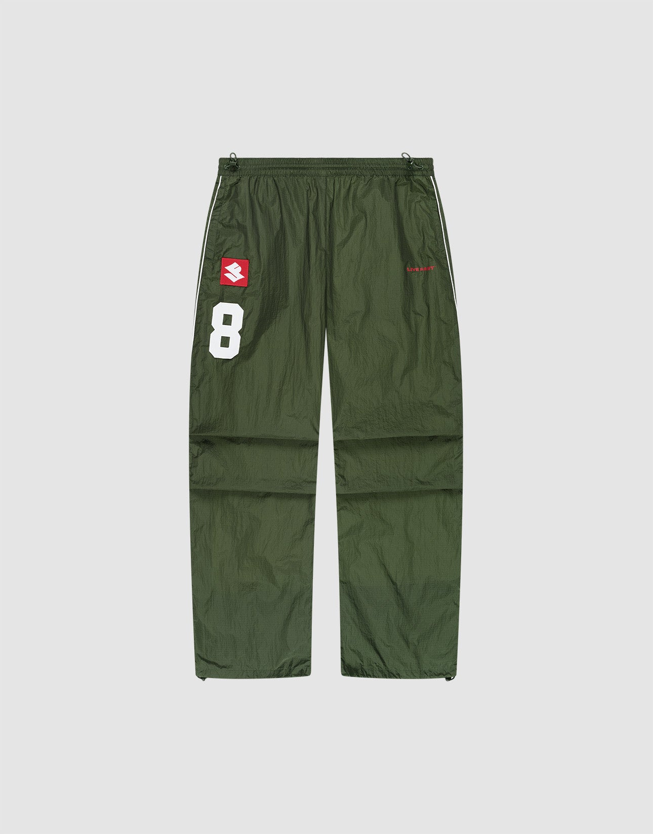 The LFDY Nylon Trackpants by LIVE FAST DIE YOUNG feature an olive green polyamide wide fit, a white number 8 and red-and-white logo patch on the left thigh, plus a small red logo on the right thigh, shown on a plain light background.