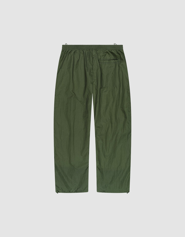 The LFDY Nylon Trackpants by LIVE FAST DIE YOUNG feature olive green, lightweight polyamide nylon, an elastic waistband, wide straight legs, and a single back pocket, shown flat on a plain white background.