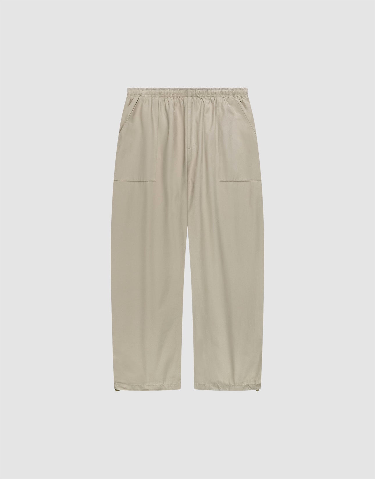 Baggy Nylon Pants by LIVE FAST DIE YOUNG in beige with a wide fit, elastic waistband, and large patch pockets, shown flat on a plain white background.