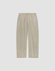 Baggy Nylon Pants by LIVE FAST DIE YOUNG in beige with a wide fit, elastic waistband, and large patch pockets, shown flat on a plain white background. | plain