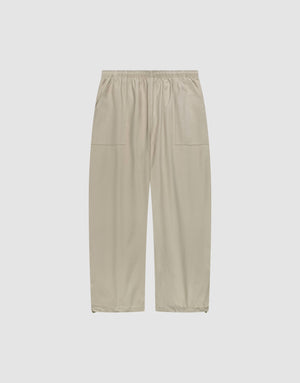 Baggy Nylon Pants by LIVE FAST DIE YOUNG in beige with a wide fit, elastic waistband, and large patch pockets, shown flat on a plain white background. | plain