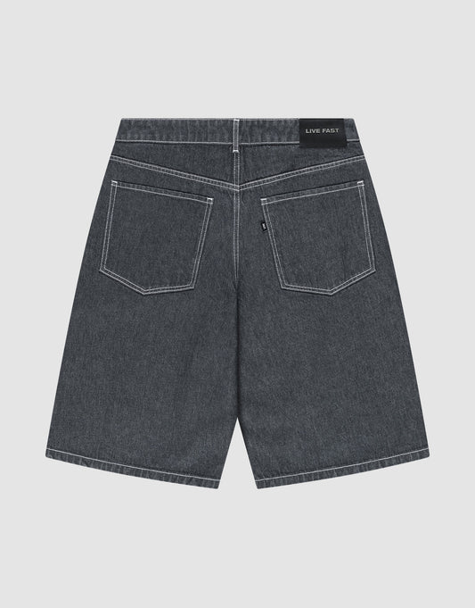 The LFDY Jorts by LIVE FAST DIE YOUNG are shown from the back, displaying a baggy fit, two large rear pockets with white stitching, and a black “LIVE FAST” Lederpatch on the waistband. The dark gray shorts are laid flat on a light background.