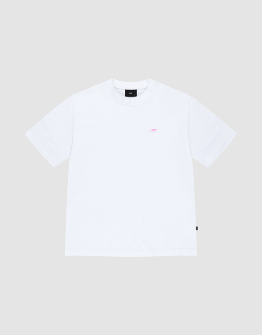 The LIVE FAST DIE YOUNG Basic Evidence Tee is a plain white oversized short-sleeve shirt made from 100% cotton, shown laid flat on a light gray background with small pink LEFT text on the upper left chest.